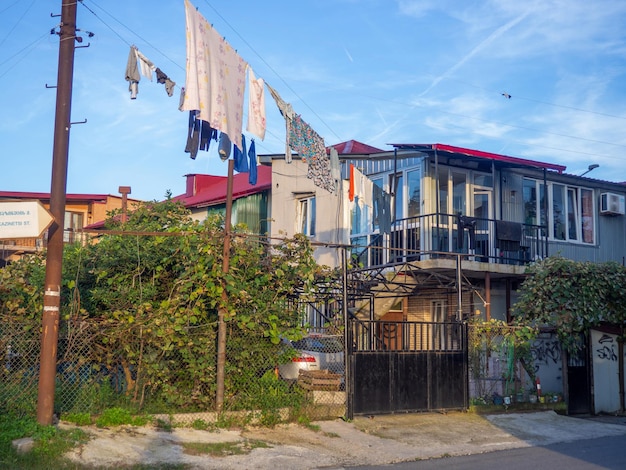 House on the outskirts of the city Colorful home Linen on a rope in the yard Drying things