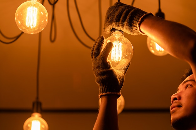 House owner changing vintage light bulb