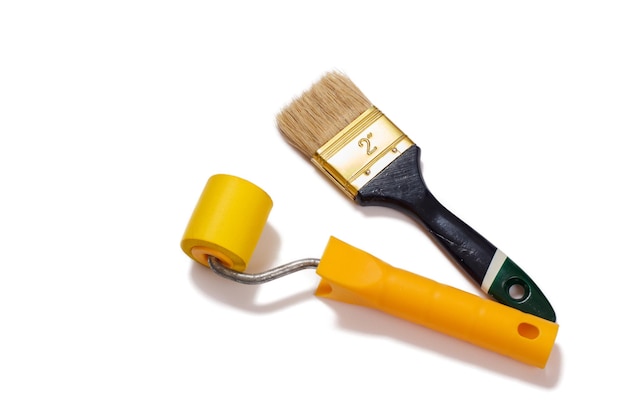 House painter brush and roller on a white isolated background. Repair tool. Building tool. Top view.