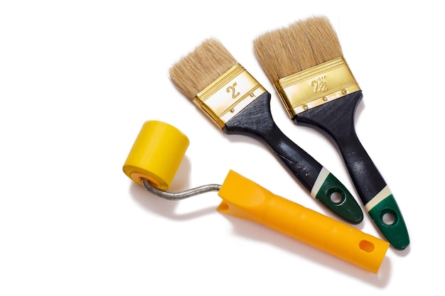 House painter brushes and roller on a white isolated background. Repair tool. Building tool. Top view.