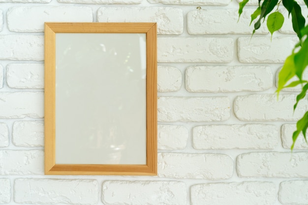 House plant leaves against white brick wall with copy space