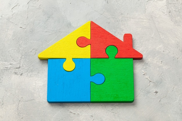 Photo house puzzle home loan. parts of the house are brought together.