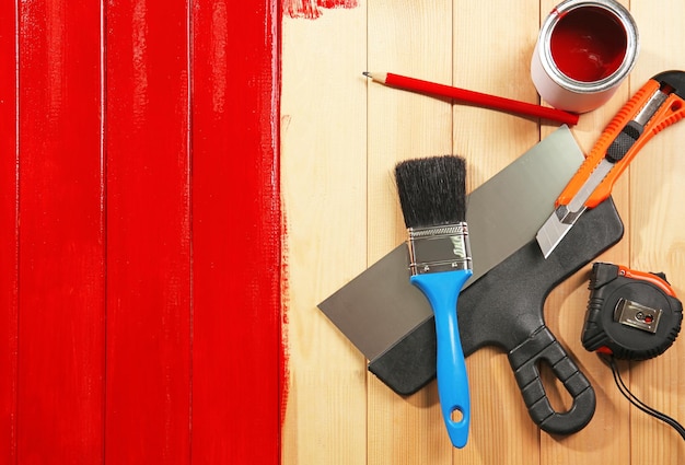 Photo house renovation tools on red painted wooden background