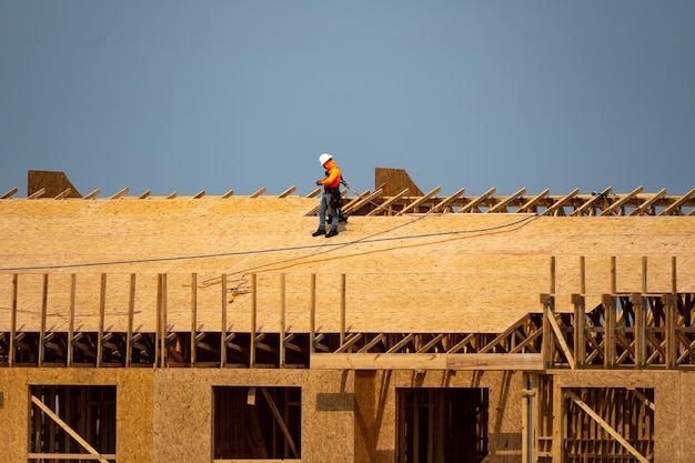 House roof roofing construction roofer using air nail roofing tiles of the new roof under