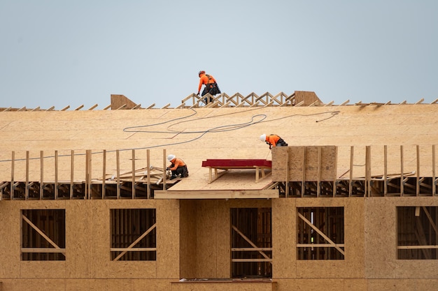 House roof roofing construction roofer using air nail roofing tiles of the new roof under