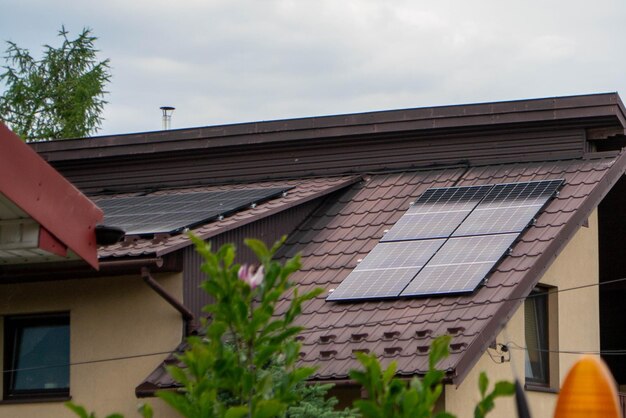 House roof with photovoltaic modules. Historic farm house with modern solar panels on roof and wall