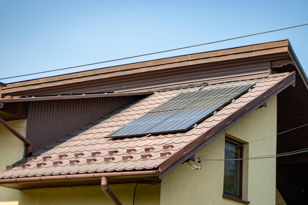 House roof with photovoltaic modules. Historic farm house with modern solar panels on roof and wall