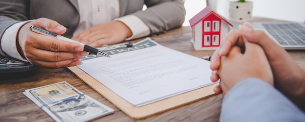 House signers signing signature loan document to home ownership with real estate agents ownership. Mortgage and real estate property investment, home insurance