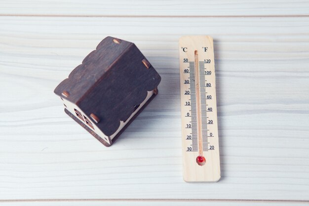 House and thermometer on the table