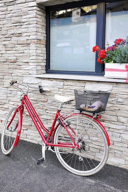 House with bicycle at center of Zermatt, Valais, Switzerland in summer.