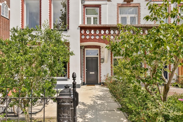 A house with a black door and a sidewalk