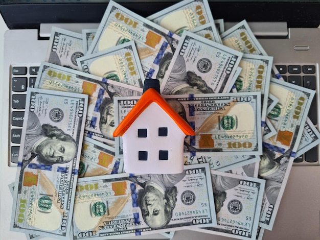 House with computer keyboard and banknotes closeup