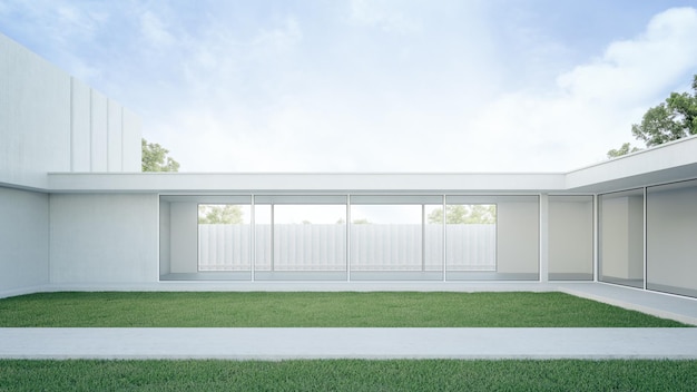 House with concrete terrace near empty grass floor courtyard.