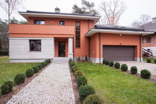 A house with a driveway and a garage in the background