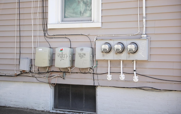 A house with a lot of electrical meters on the side of it