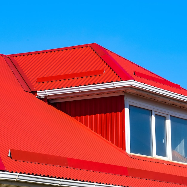 House with plastic windows and a red roof of corrugated sheet