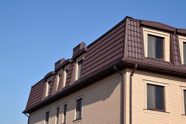 Photo the house with plastic windows and a roof of corrugated sheet