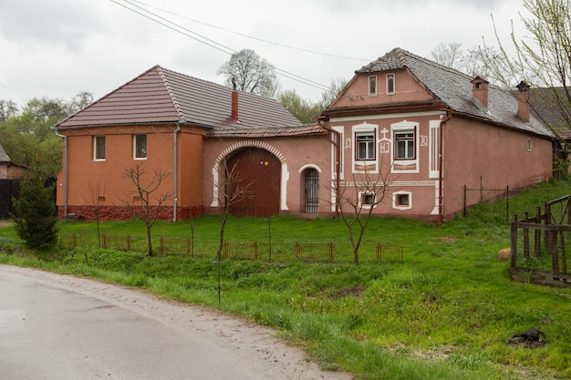 A house with a red roof and a white door