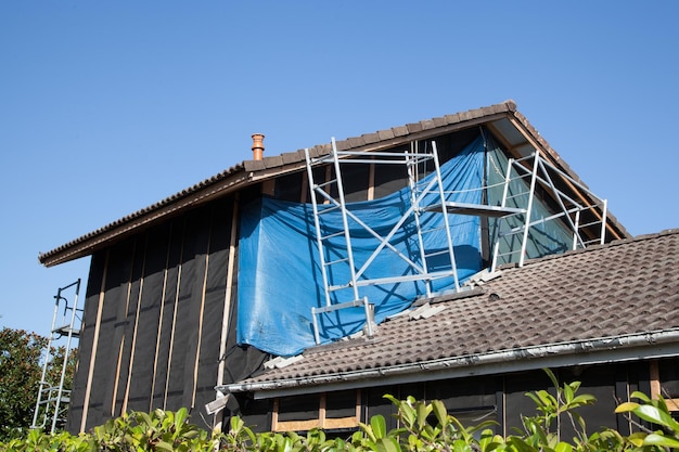 House with tarpaulin