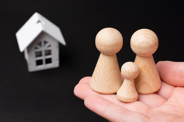 House and wooden figurines as life insurance concept