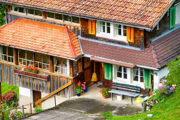 House and yard design in the old style The facade of an apartment building Pots of flowers