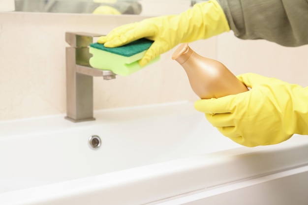 Household chemicals Biodegradable Chrome and Metal Cleaner For Stainless Steel Woman Hands hold Mockup of Bottle Cleaning solution Acrylic bathtub cleaning disinfection and hygiene concept