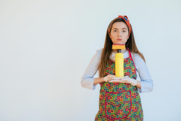 Housekeeper in uniform with clean spray sponge housekeeper or happy wife cleaning with soap bottle