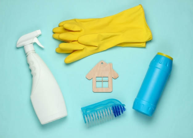 Housekeeping concept. Set of products for cleaning and house figure on blue pastel background. Top view.