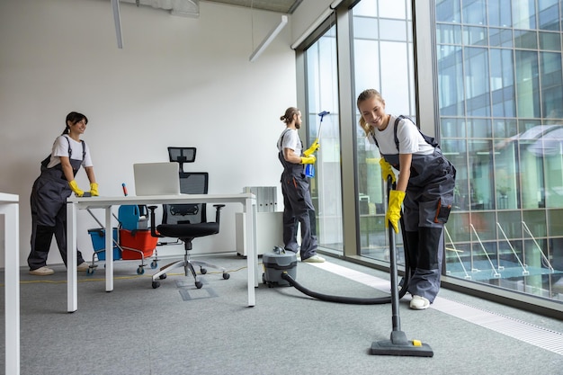 Housekeeping team cleaning the conference room and looking busy and involved