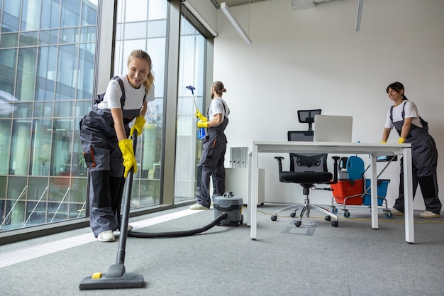 Housekeeping team cleaning the conference room and looking busy and involved