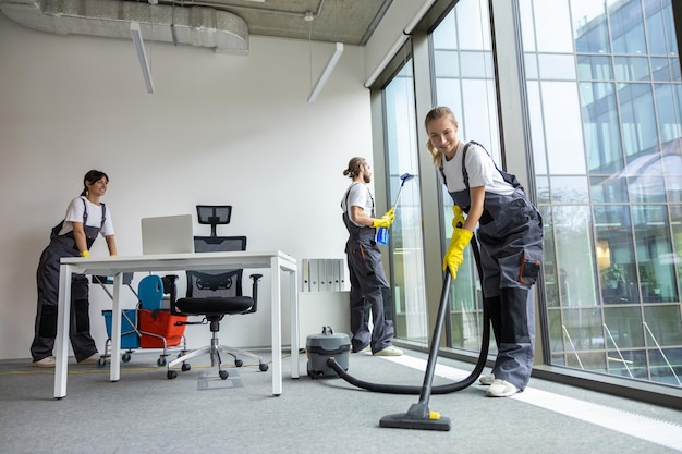 Housekeeping team cleaning the conference room and looking busy and involved