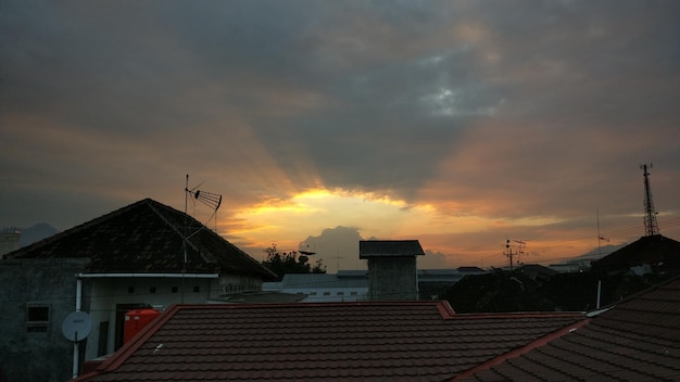 Houses against sky during sunset