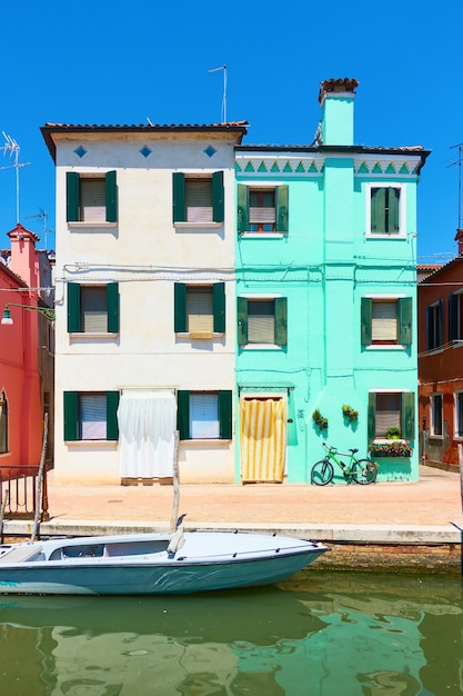 houses by canal in burano in venice, italy - italian cityscape