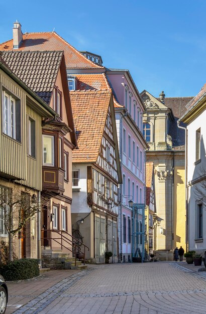 Houses by street in city against sky