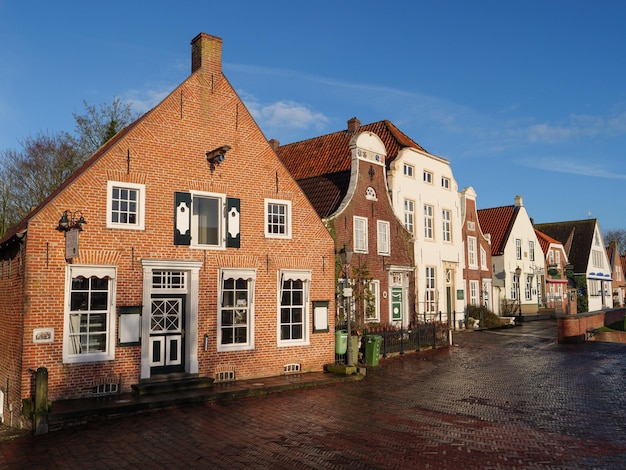 Houses by street in town against sky