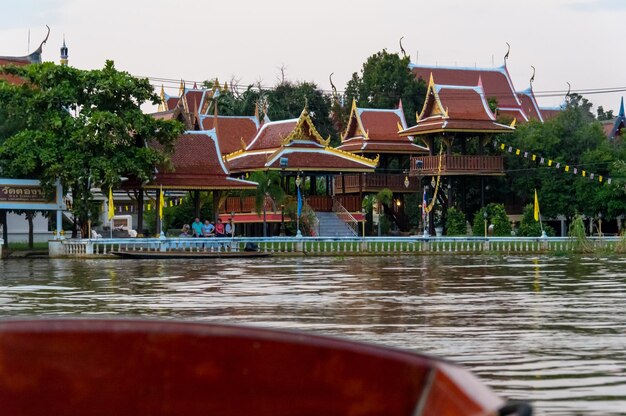 Houses by swimming pool by lake against sky