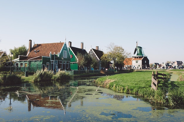 Houses by water against clear sky