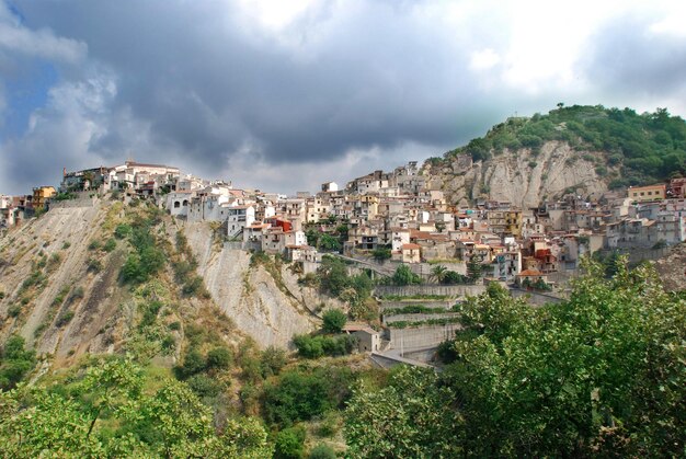 Houses in corleone on mountains against cloudy sky