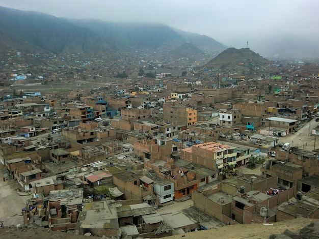 Houses of different construction materials in a lowincome human\
settlement in peru