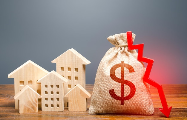 Houses and dollar money bag with down arrow Falling of real estate market prices