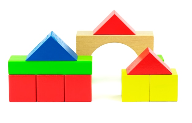 Houses made from toy wooden colorful building blocks on a white background