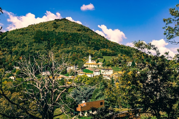 Houses on mountain against cloudy sky