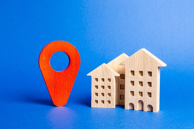 Houses and red navigation pointer pin location of residential buildings or work city orientation Checking the location of a new apartment for infrastructure facilities parks and other