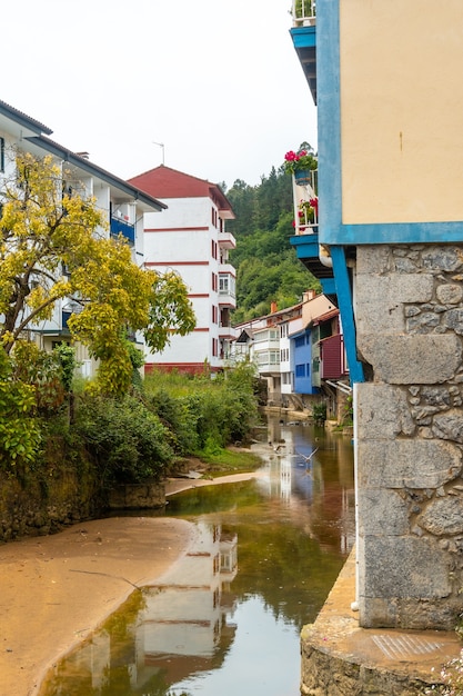 Houses on the river of the Ea municipality near Lekeitio, Bay of Biscay in Cantabria. Basque Country