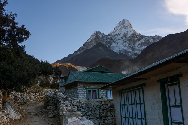 Houses and snowcapped mountains against sky