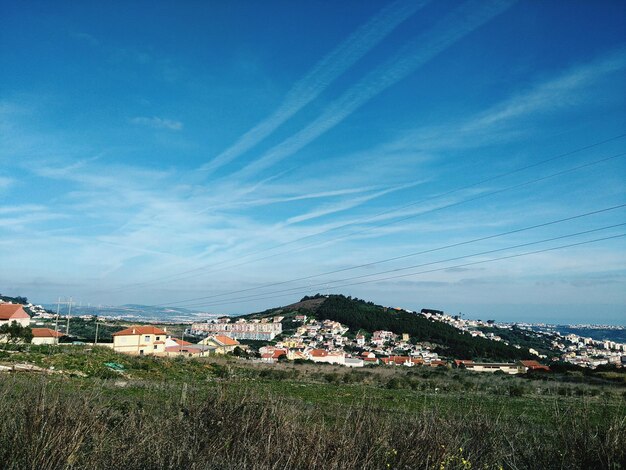 Houses in town against blue sky