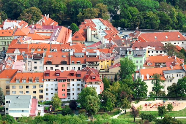 Houses with red tile roofs and green trees in a beautiful old city