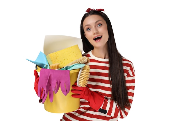 Housewife girl with means for cleaning the house on a gray background