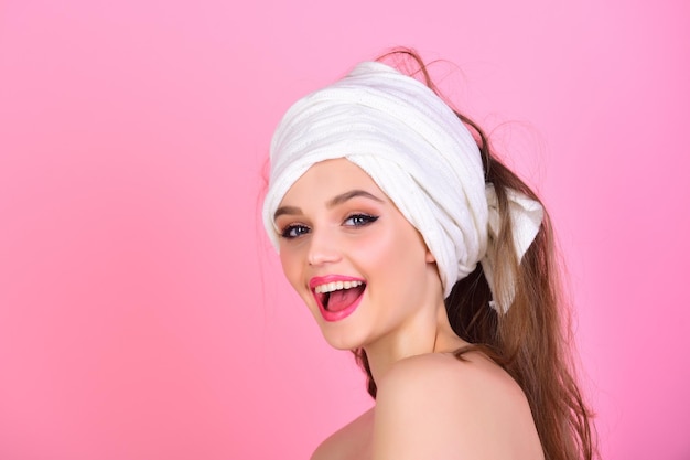Housewife has makeup with towel or headscarf Girl with fashionable turban on hair Fashion and beauty spa Morning after bath washing and hair clean Sexy woman with towel on head after shower