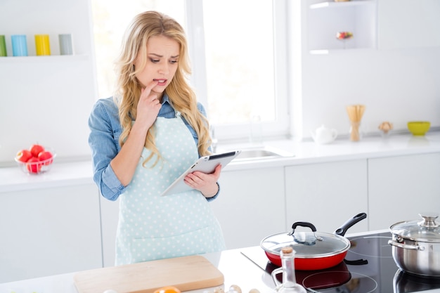 housewife lady hold digital tablet searching recipe internet